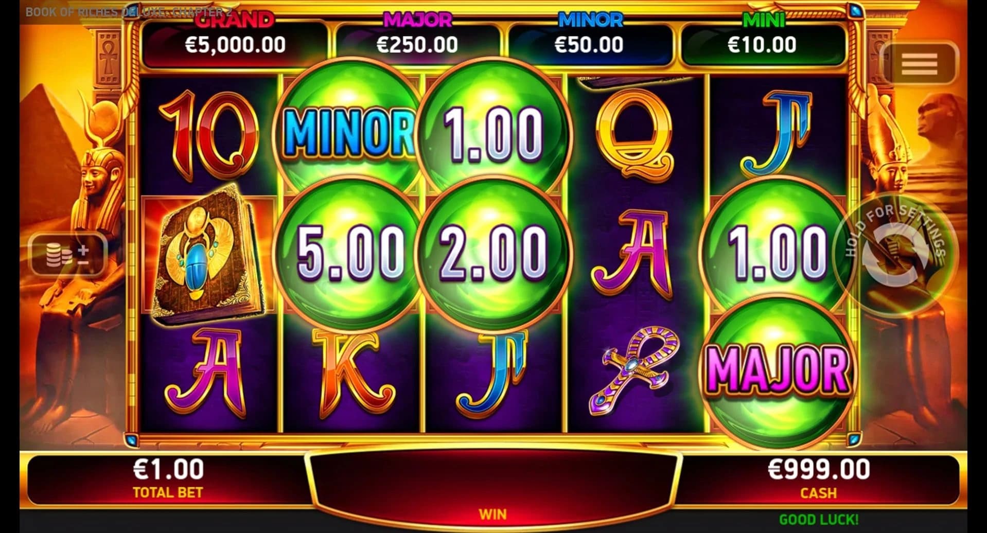 Book of Riches Deluxe: Chapter 2: Main Chapter 2 reel field with green Prize Orbs and named jackpot tokens.